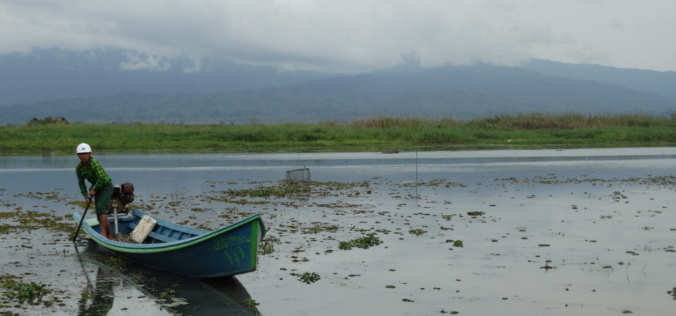 man in boat on lake